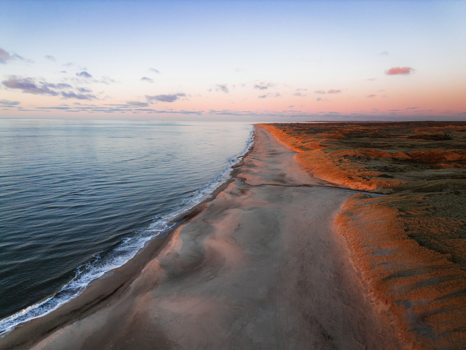 An aerial view of a beach at sunset